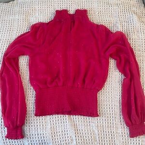 Pinkish red long sleeve sheer top.